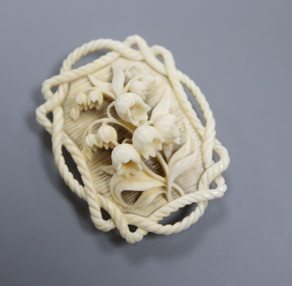 A 19th century Dieppe ivory pendant, carved with lily of the valley